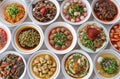 Top view of many plates on dinner dishes from different dishes covered in sauce on white background Royalty Free Stock Photo