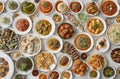 Top view of many plates on dinner dishes from different dishes covered in sauce on white background Royalty Free Stock Photo