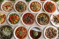 Top view of many plates on dinner dishes from different dishes covered in sauce on white background Royalty Free Stock Photo