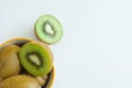 Top view of many sliced of kiwifruits in bowl on a white background with copy space Royalty Free Stock Photo
