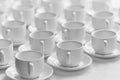 Top view on many stacked in rows of empty clean white cups for t Royalty Free Stock Photo