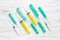 Top view of many syringes prepared for injection at wooden background. Treatment concept with copy space