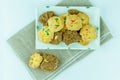 Top view many variety homemade cookies in plate on fabric and white background.