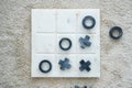 Top view marble Tic Tac Toe or OX board game on soft carpet with copy space. concept of strategy, risk, competition in business Royalty Free Stock Photo