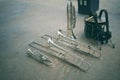 Top view of marching band instruments: trombones, trumpets, saxophones and euphonium drums laying on the floor.