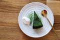 Top view Matcha green tea cake with whipping cream in the white plate on wooden table background. Japanese dessert concept Royalty Free Stock Photo