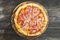 Top view of meat lovers pizza with topping pepperoni salami sausage and ham on wooden table Royalty Free Stock Photo