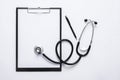 Top view of medical concept with stethoscope, clipboard and pen on white desk Royalty Free Stock Photo