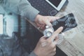 top view of medical doctor hand working with smart phone,digital tablet computer,stethoscope eyeglass,on wooden