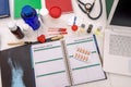 Top view at medical results and notepads on table
