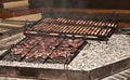 Steak and duck breasts, grilled over open fire pit in wine cellar