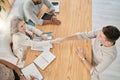 Top view, meeting and handshake of business people in office. Welcome, partnership and group of employees shaking hands Royalty Free Stock Photo