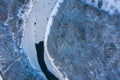 Top view of melting ice in a flowing river through the snow-covered forest on a winter day Royalty Free Stock Photo