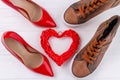 Top view of mens and womens shoes on white desk. Royalty Free Stock Photo