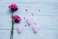 Menstrual cups with pills and roses on table