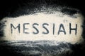 Top view of Messiah word written on sand