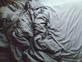 Top view of messy crumpled blanket is on the bed in bedroom Royalty Free Stock Photo