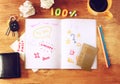 Top view of messy table with notebook with doodles, coffee cup, papers and keys. Royalty Free Stock Photo