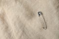 Top view of metal safety pin on clothing Royalty Free Stock Photo