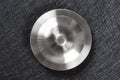 Metal sink plug on dark background