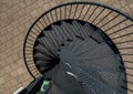 Top view of a metallic spiral staircase at a park after the rain Royalty Free Stock Photo