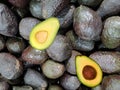 Top view of mexican avocados, whole and cut in half