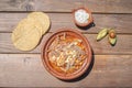 Top view Mexican food dish. pozole with toasts, avocado and onion