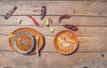 Top view Mexican food, plate of birria and pozole with sauce and Mexican chili peppers, tomato and avocado