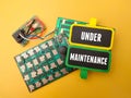 microcip board with the word UNDER MAINTENANCE Royalty Free Stock Photo