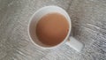 Top view of milk black tea in a ceramic cup placed over a mat sheet Royalty Free Stock Photo