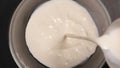 TOP VIEW: Milk pours into a mixing bowl