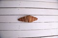 Top view of mini croissant on a white wooden table