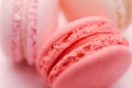 Top view of mini pink and white macaron on soft sweet pink paper