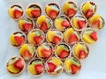 Top view of mini tarts with fresh strawberries, orange and kiwi isolated Royalty Free Stock Photo