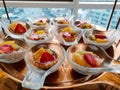 Top view of mini tarts with fresh strawberries, orange and kiwi on spoon Royalty Free Stock Photo