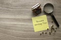 Top view of miniature typewriter, magnifying glass, gold alphabet beads and yellow paper note written with Resume Writing Tips on
