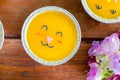 Top view minimal orange cake with butter cream smile in foil cup on wooden table. Delicious bakery in coffee and tea times Royalty Free Stock Photo