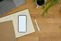 Top view, Minimal wood tabletop workspace with smartphone mockup, pen, notepad, laptop Royalty Free Stock Photo