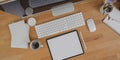 Top view of minimal workplace with blank screen tablet, desktop computer and office supplies Royalty Free Stock Photo