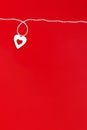 Top view of a minimalistic composition for Valentine`s day on a red background with white and red hearts and a white