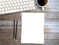 Top view Minmal workspace with keyboard, white paper and coffee cup on wood table background