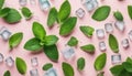 Top view of mint leaves with ice cubes and water drops on pastel background