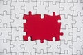 Top view of missing jigsaw puzzle on red cover background. Copy space Royalty Free Stock Photo
