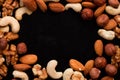 Mix of nuts frame on a black table Royalty Free Stock Photo