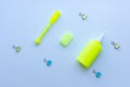 Top view of mixed stationery in yellow and blue colours: clips, eraser, glue and marker pen on white background. Concept of educat