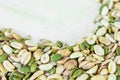 Top view of a mixture of various nuts: sunflower seeds, pumpkin and peanuts. Vegan. Healthy vegetable fats. The concept