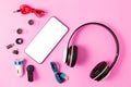 Top view mobile device with mobile blank space for text,.accessories. micro USB Adapter, macro lens and headset on pink background Royalty Free Stock Photo
