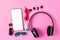 Top view mobile device with mobile blank space for text,.accessories. micro USB Adapter, macro lens and headset on pink background Royalty Free Stock Photo