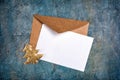 Top view of mock-up blank white greeting christmas card with brown envelope and golden tree Royalty Free Stock Photo