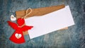 Top view of mock-up blank white greeting christmas card with brown envelope and red angel Royalty Free Stock Photo